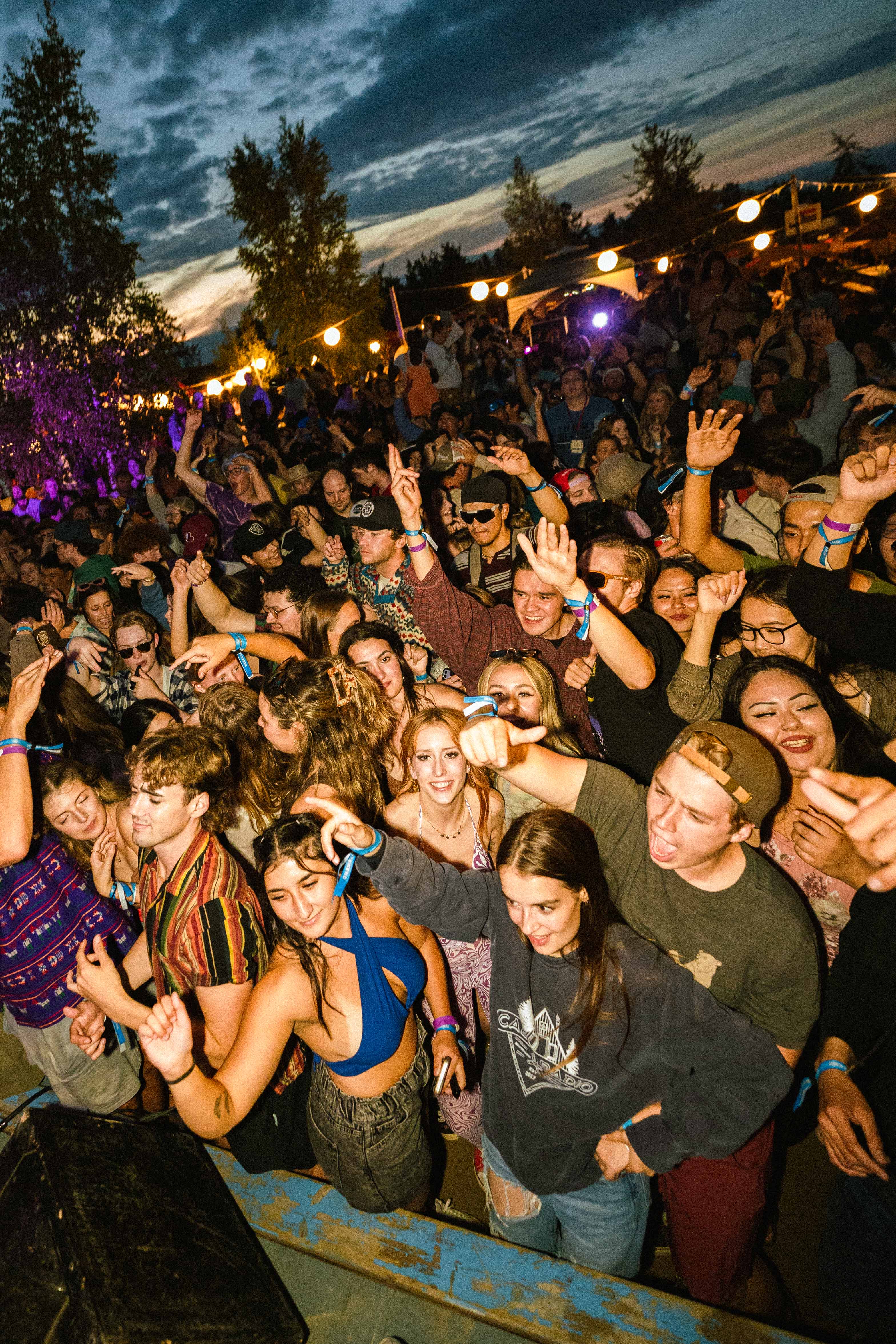 Festival-goers dance in front of stage